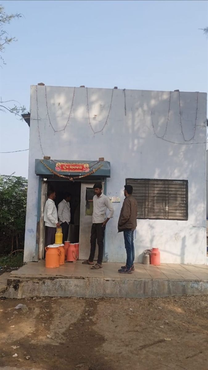 A village BMC (bulk milk cooler) in rural India with farmers' milk cans at the entrance
